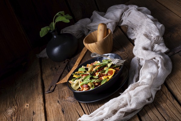 Pasta salad with green asparagus, olives and Parma ham