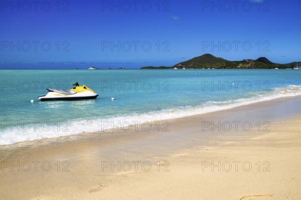 Jolly Beach a beach in Antigua in the Caribbean with azure blue sea and a jet ski
