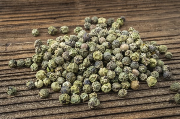 Dried spices green pepper. Peppercorn on dark rustic wooden background