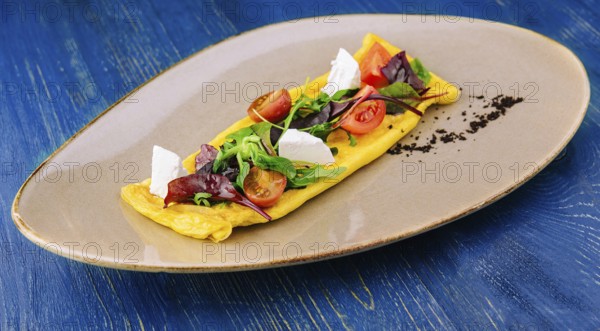 food still-life, Omelette with cherry tomatoes and goat cheese
