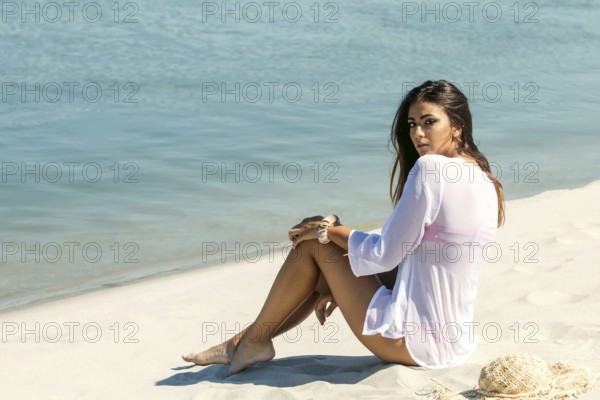 Young woman enjoying sunny day on tropical beach