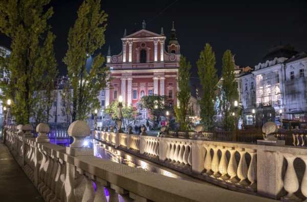 Famous Three Bridges and the Preseren square in the center of Ljubljana illuminated at night, Slovenia