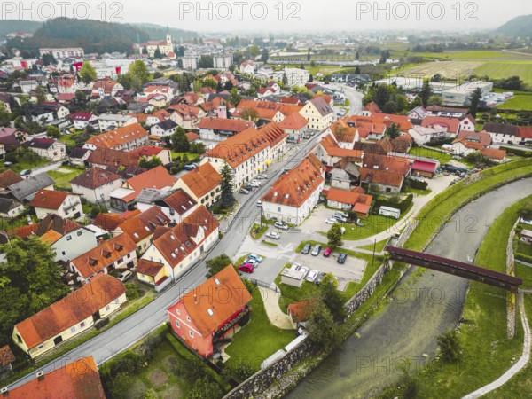 Drone stills of a small town in the countryside in autumn. River running trough the town, aerial view
