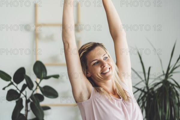 Cheerful happy caucasian woman relaxing at home on her day off work. Adult content woman spending time at home, in her apartment, resting on the couch, having a cup of coffee, feeling good