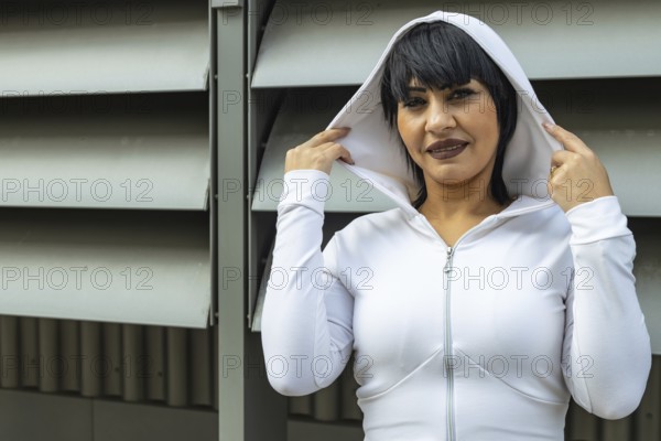 Young cute black hair woman posing with stylish hoodie