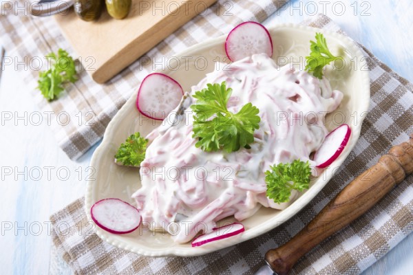 Delicious homemade meat salad with mayonnaise and cucumber