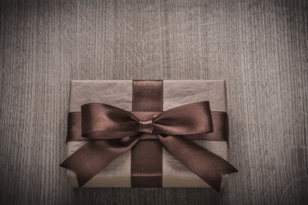 Wrapped vintage present box with tied brown bow celebration concept