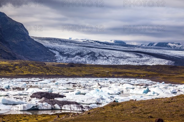 Sunrise in the Ice Lagoon. Drift ice Ice Lagoon - Jokulsarlon. Ice floes are reflected in the smooth water surface. The concept of extreme northern tourism