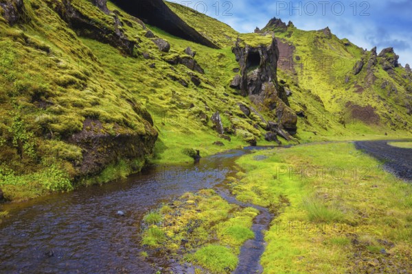 Picturesque basalt hills covered with green grass and moss-polar. At the bottom of the canyon flowing streams lot. Canyon Pakgil in Iceland