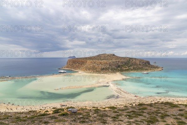 A picture of the blue water of Balos Beach and the nearby landscape of the Gramvousa Peninsula