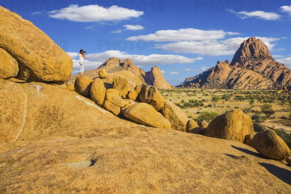 Travel to Africa. Woman photographs of a beautiful landscape. Picturesque stones in the Spitskoppe desert. The concept of active, extreme and photo-tourism