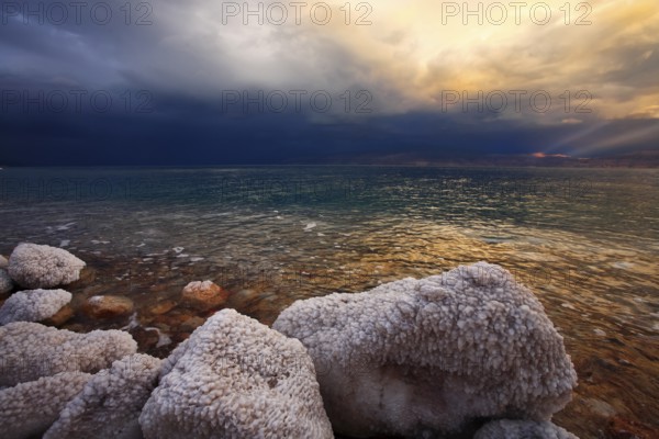 Coast of the Dead Sea in Israel in a spring thunder-storm. The coastal stones covered by salty adjournment
