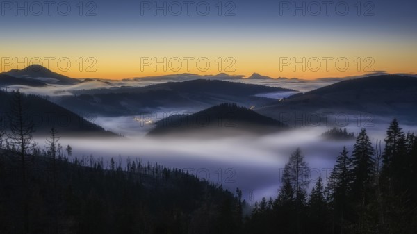 Fog over the Liptov village of Velke Borove before sunrise by Liptovska Mara in Slovakia