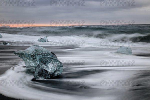 Ice floes on the black sea sand and the coast Jokulsarlon