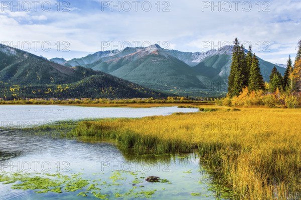 Lake Vermillon among the yellow fall grass. Grandiose landscape in the Rocky Mountains of Canada
