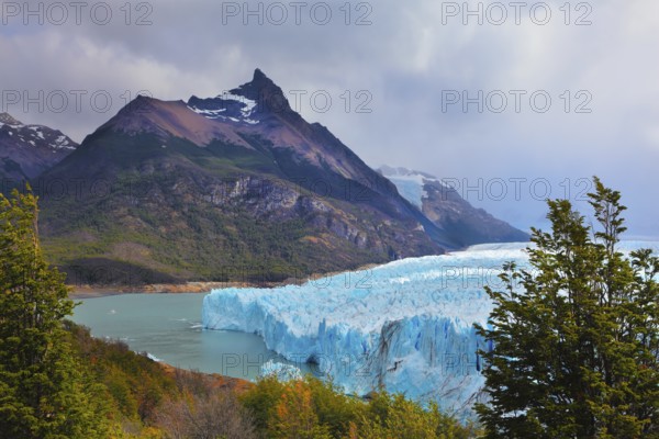Los Glaciares National Park in Patagonia. Huge Perito Moreno glacier in the Lake Argentino, surrounded by mountains. Sunny summer day