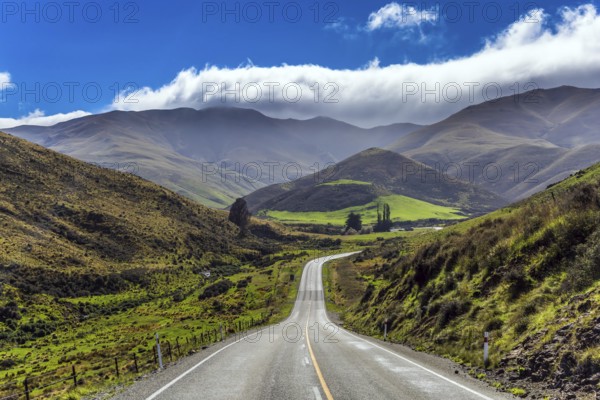 Magnificent highway in New Zealand amid fields and mountains. South Island. Concept of active and ecological tourism