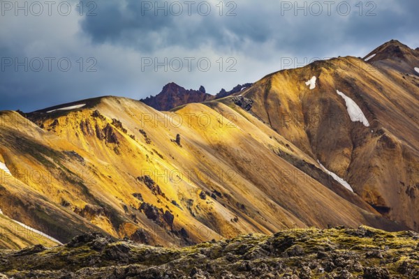 Multicolored rhyolite mountains scenic highlights the July sun. Travel to Iceland in the summer