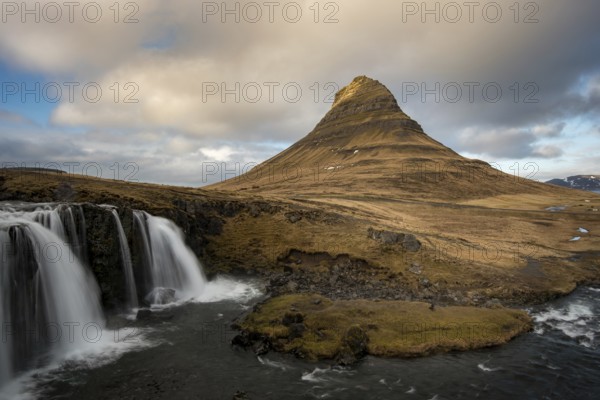 The Kirkjufell mountain and the kirkjufellfoss waterfall at grundarfjordur at Snaefellsnes peninsula in Iceland