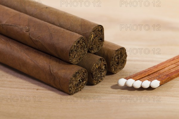 Different cigars on wooden table