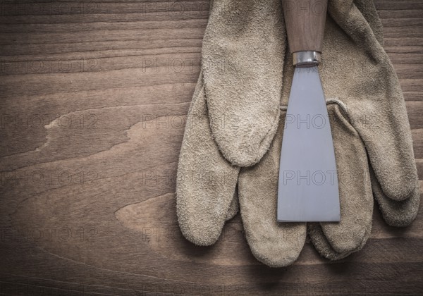Paint scraper on safety glove