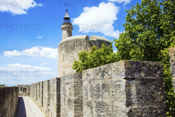 Antique walls of the medieval port city of Aigues-Mortes. The historic tower of Constance. Mediterranean coast of France. The concept of active, historical and photo tourism