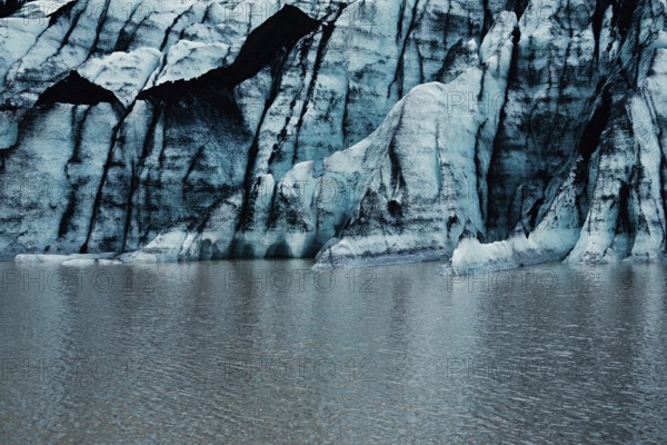 Blue glacier wall with striped pattern reflected on calm water, iceberg Iceland, glacier, snow, ice rock, ice diamont, glacier lagoon, nature, snow, diamont beach, Iceland