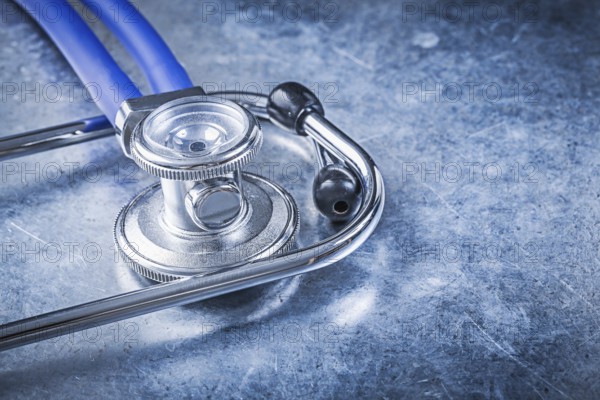 Stethoscope on scratched metallic background top view medicine concept