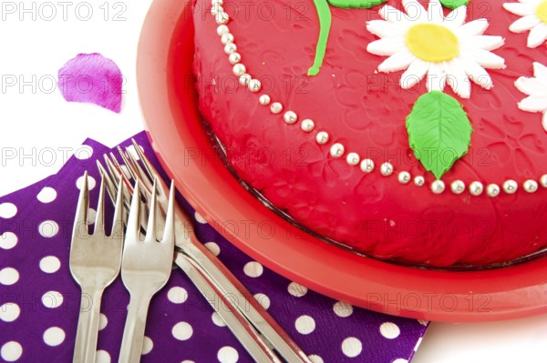 Birthday cake in pink with napkins and forks