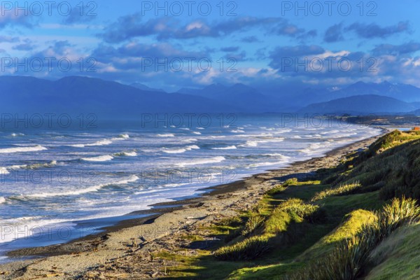 Powerful ocean surf on South island. Sunset. Rocky and stone shores of the ocean. The southernmost point of New Zealand. The concept of ecological and photo tourism