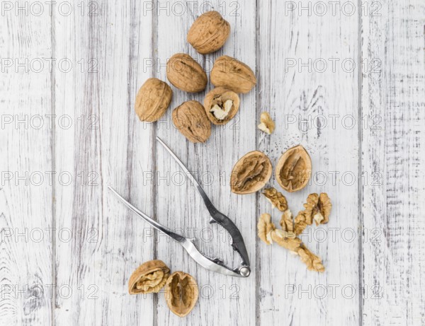 Walnuts on an old wooden table as detailed close-up shot (selective focus)