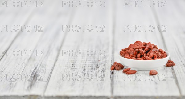 Fresh made Dried Goji Berries on a vintage background (close-up shot)