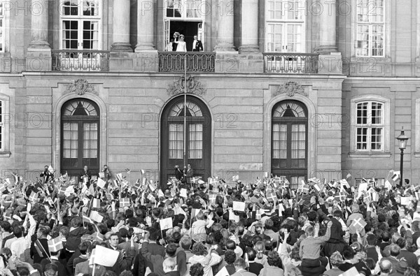 Margrethe II of Denmark. Pictured with Henri de Laborde de Monpezat at Fredensborg palace in Copenhagen after their wedding on June 10 1967. Greeted by a crowd of people waving flags