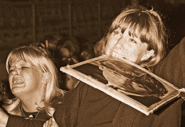 Beatles in the 1960s. Fans at a Beatles concert in Stockholm 1964 July 28 on Johanneshov stadion. Pictured a scene from the concert and the audience who is in extacy. The girl on the right is holding a portrait of Ringo Starr in her mouth
