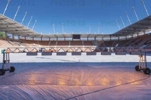 LUBIN, POLAND - MARCH 19, 2018: Stadium Zaglebie with covered turf to protect against frost and lighting grass in shaded areas. Football World Championship U-20 on 2019 will be played at the stadium