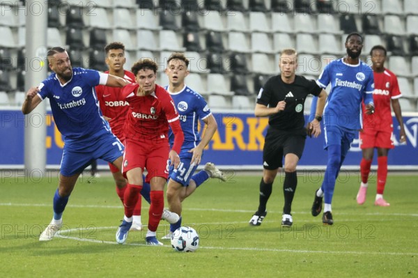 Yannick Häringer (Bahlinger SC /BSC) chases after his opponent Gabriel Carmine Pellegrion (SC Freiburg II / U23) during the Football-RL SW 24-25: 9. Sptg: SC Freiburg II vs Bahlinger SC, Freiburg im Breisgau, Germany / Germany