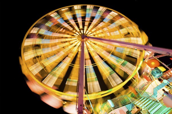 Turning illuminated ferris wheel shot at long exposure