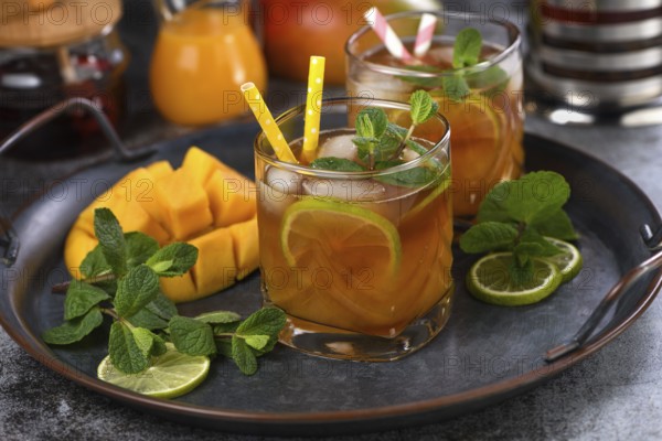 Mango iced tea with lime and mint. Refreshing organic soft drink
