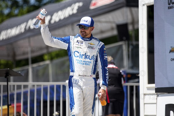 Daniel Hemric walks across the stage during driver intros prior to the Road America 180 at Road America in Elkhart Lake WI