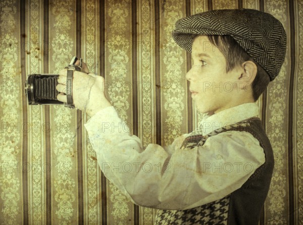 Boy with vintage camera. Vintage clothes