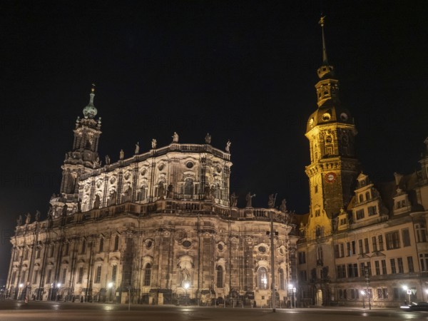 Impressive baroque church with sculptures and bell tower illuminated at night, Dresden, Saxony, Germany