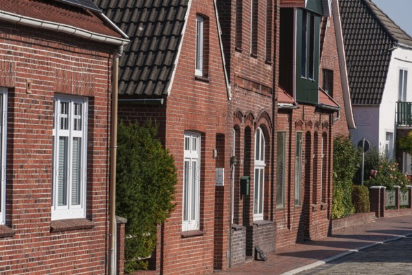 Row of historic brick houses with many windows, Ditzum, east frisia, germany
