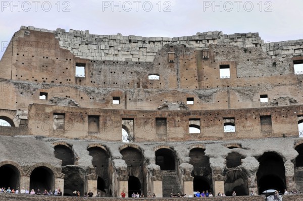 Colosseum, Colosseum, amphitheatre, built in 72 AD by Vespasian, Rome, Lazio, Italy, Exterior view of the ancient stone arches of the Colosseum in Rome, Rome, Lazio, Italy, An impressive view of the ancient Colosseum in Rome with erosion and tourist groups, Vatican, Rome, Lazio, Italy