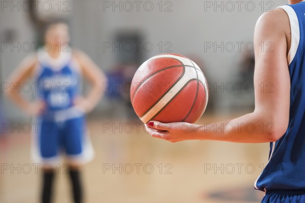Basketball player keeps ball during basketball match