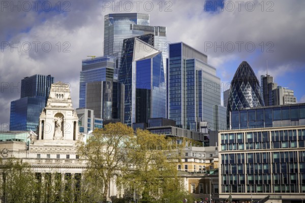 Modern London skyline with prominent skyscrapers and cloudy sky, London, England, United Kingdom