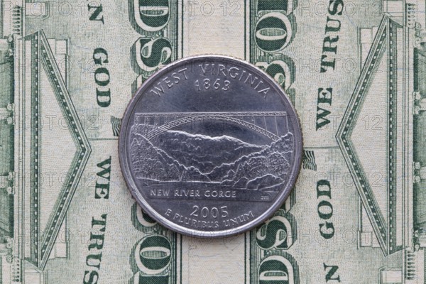 A quarter of West Virginia on US dollar bills. Symmetric composition of US dollar bills and a quarter of West Virginia