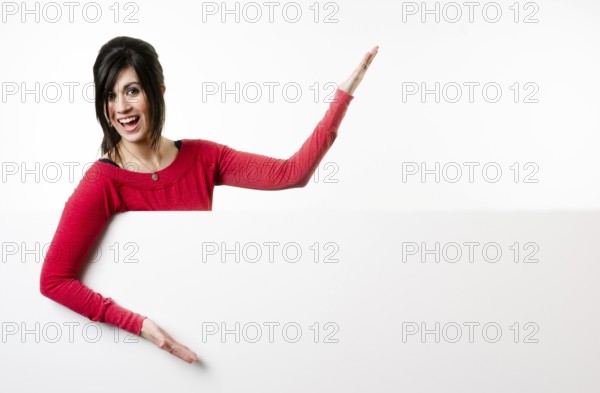 Woman smiles at she stands in between white spaces