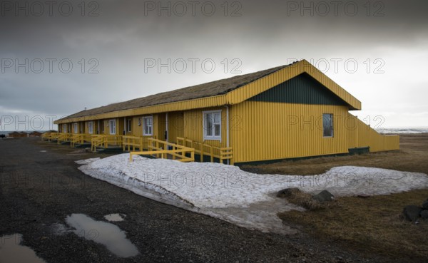 Yellow metallic cottage houses during wintertime in Iceland