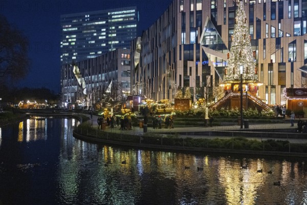 Decorated Christmas tree and Christmas market in front of the Kö-Bogen building at Corneliusplatz on Königsallee in Düsseldorf, North Rhine-Westphalia, Germany, 29 November 2024