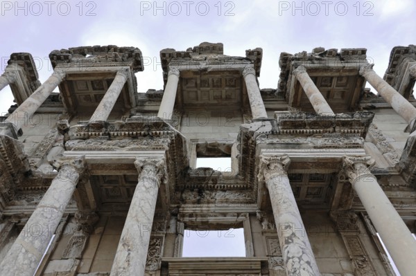 Ruins of an ancient library with impressive marble columns and detailed decorations under a blue sky, Turkey, Ephesus: tourists encounter impressive evidence of Roman and Greek history on a tour of western Turkey, Ephesus, Turkey